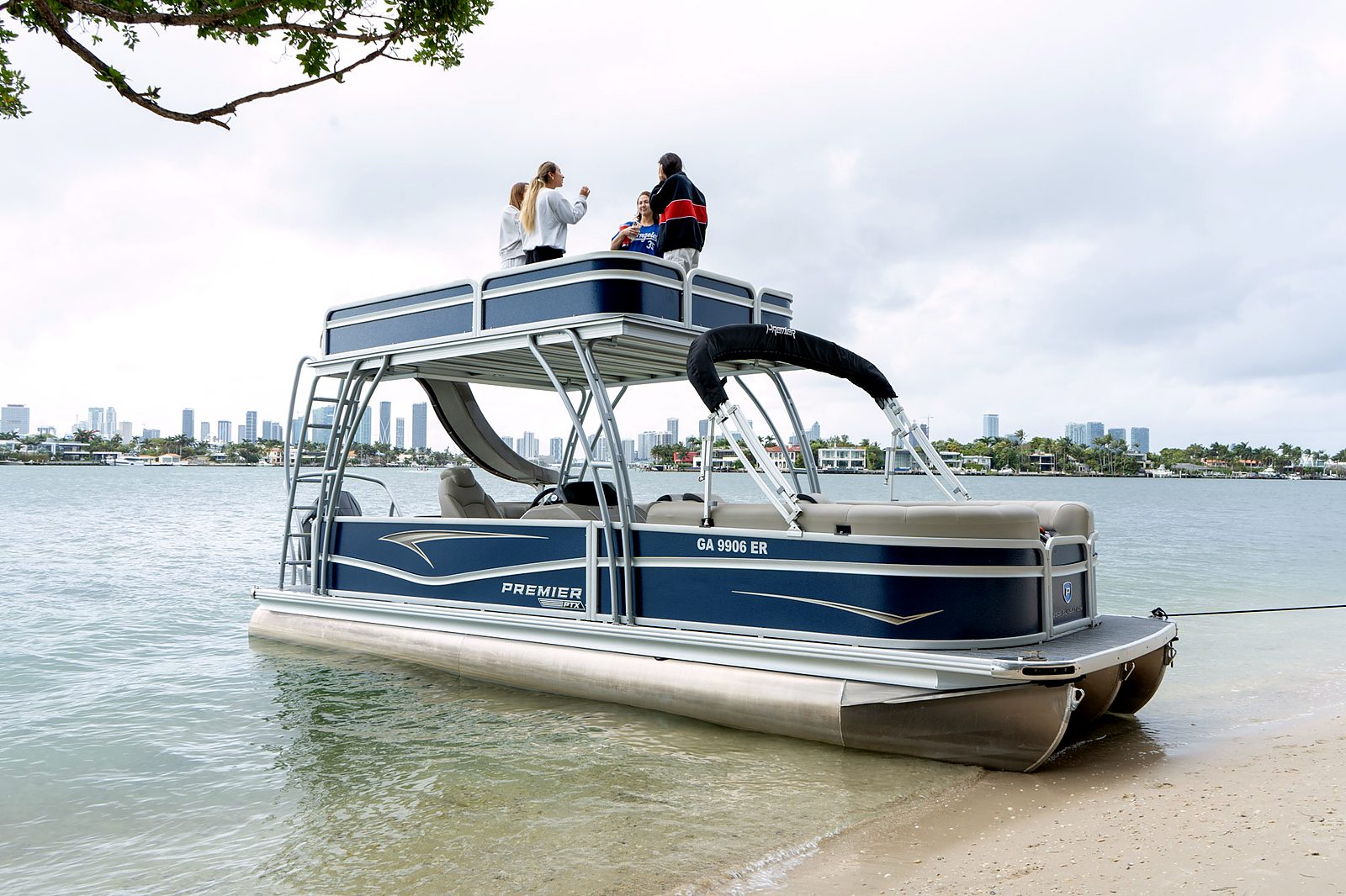 Guests on the upper deck of the tritoon beached at the shore