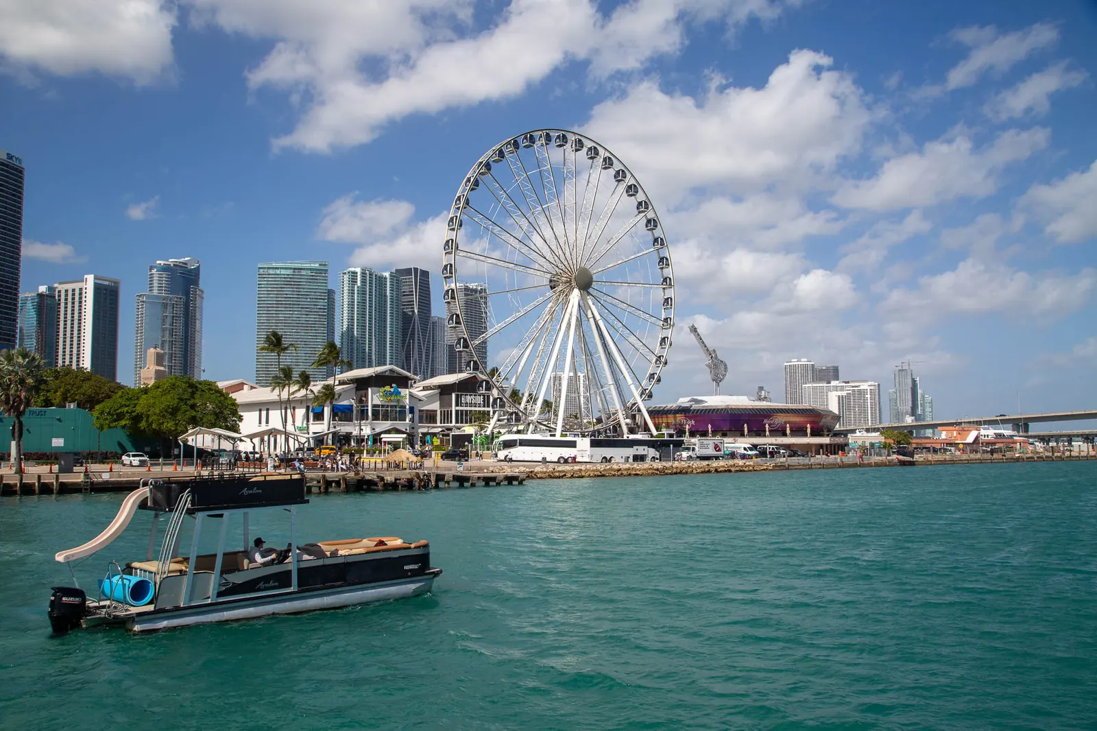 Double-deck tritoon with waterslide in front of the Miami skyline