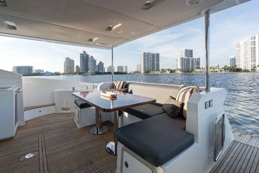 68ft Azimut yacht Paragon: Aft deck dining table under cover